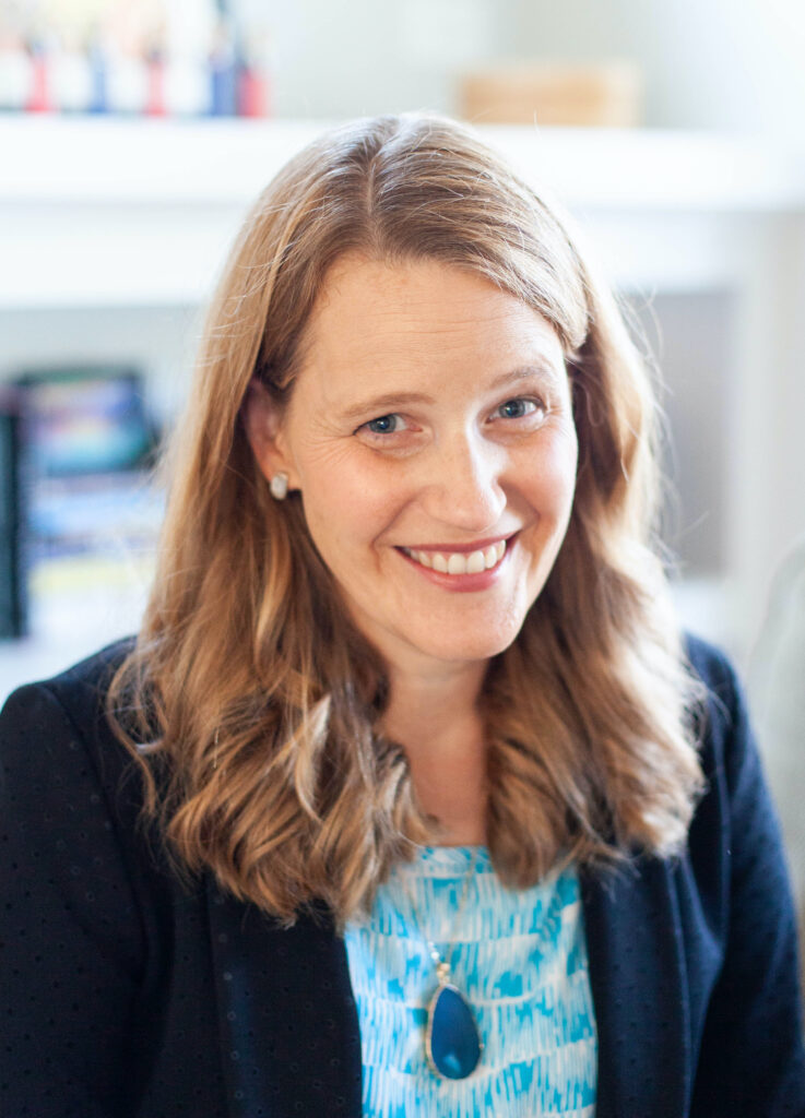Headshot of Melody Warnick with light skin, blue eyes and shoulder length reddish-blond hair
