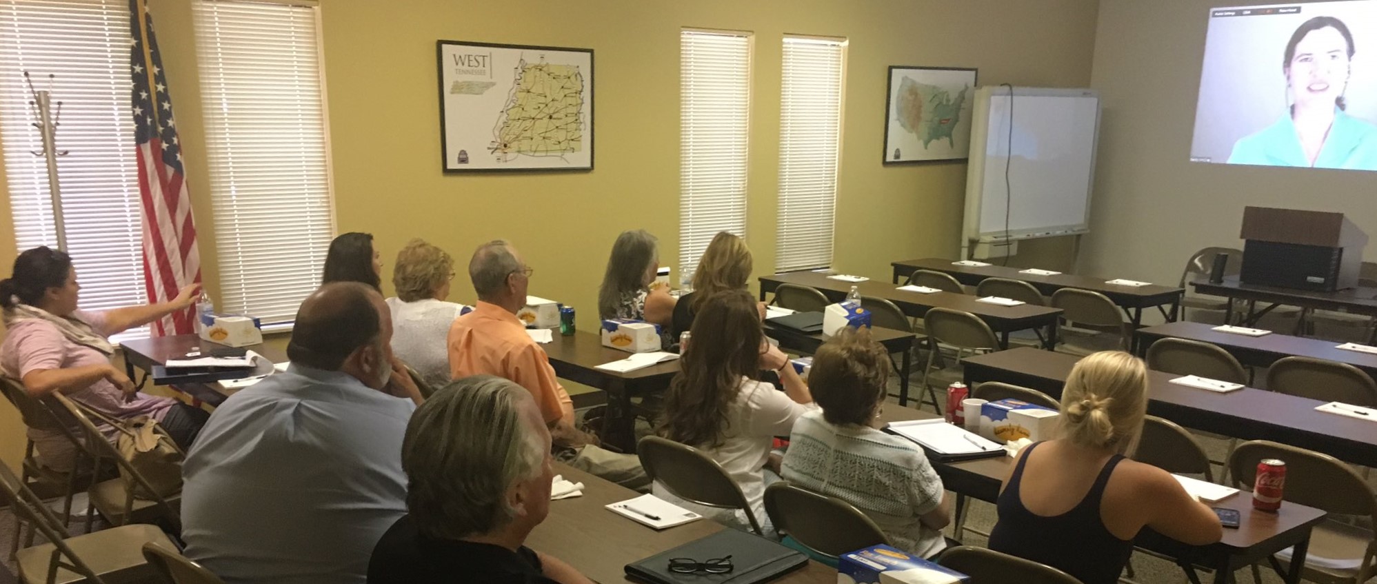 A group of people watching a virtual session from SaveYour.town